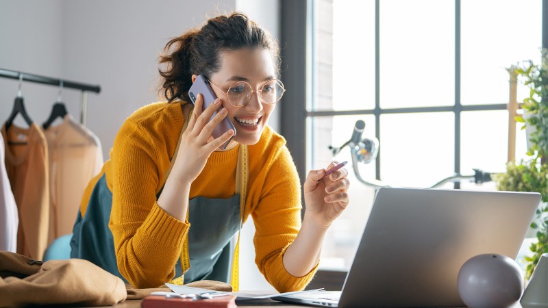 woman on the phone reading from computer