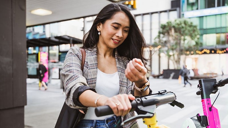 woman making watch payment for scooter