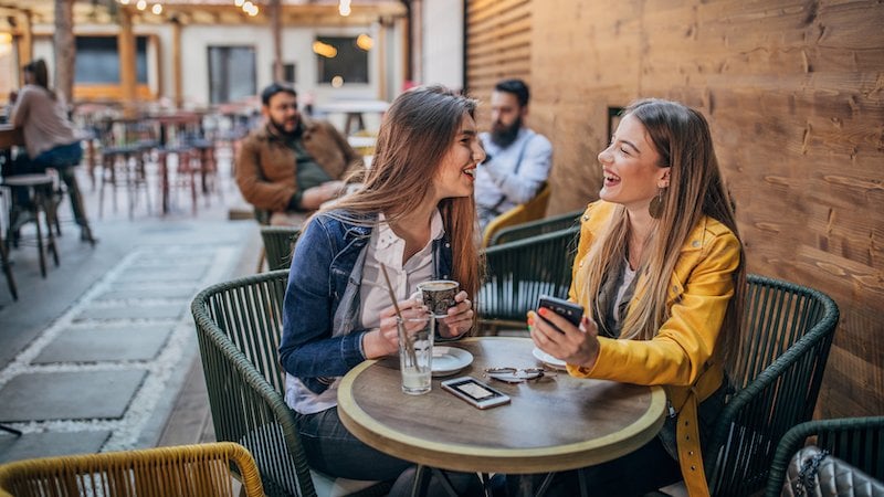 two women sitting at a table