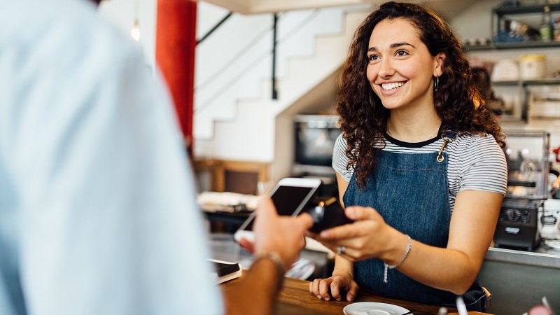 Paying with the mobile phone at the coffee shop