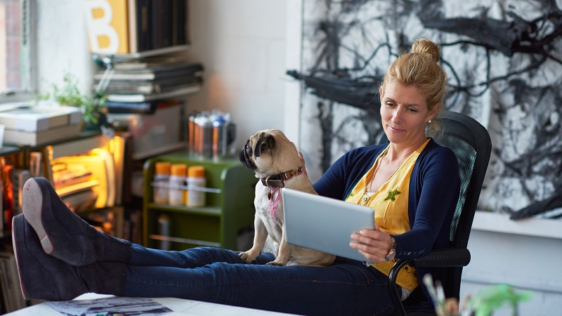 Woman sitting with digital tablet