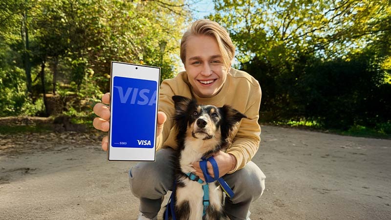 Person with dog holding phone