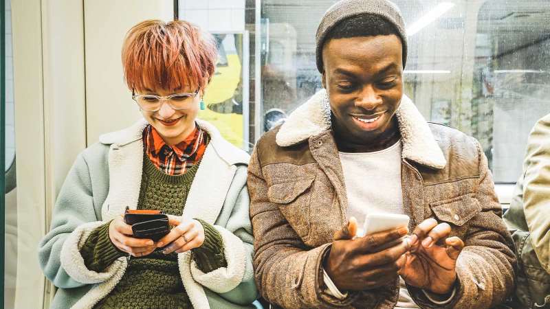 two people sitting on the underground