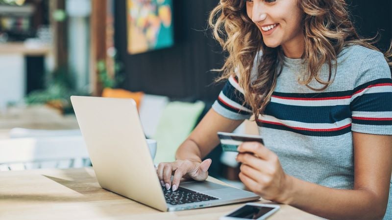 Person sitting at desk typing on laptop